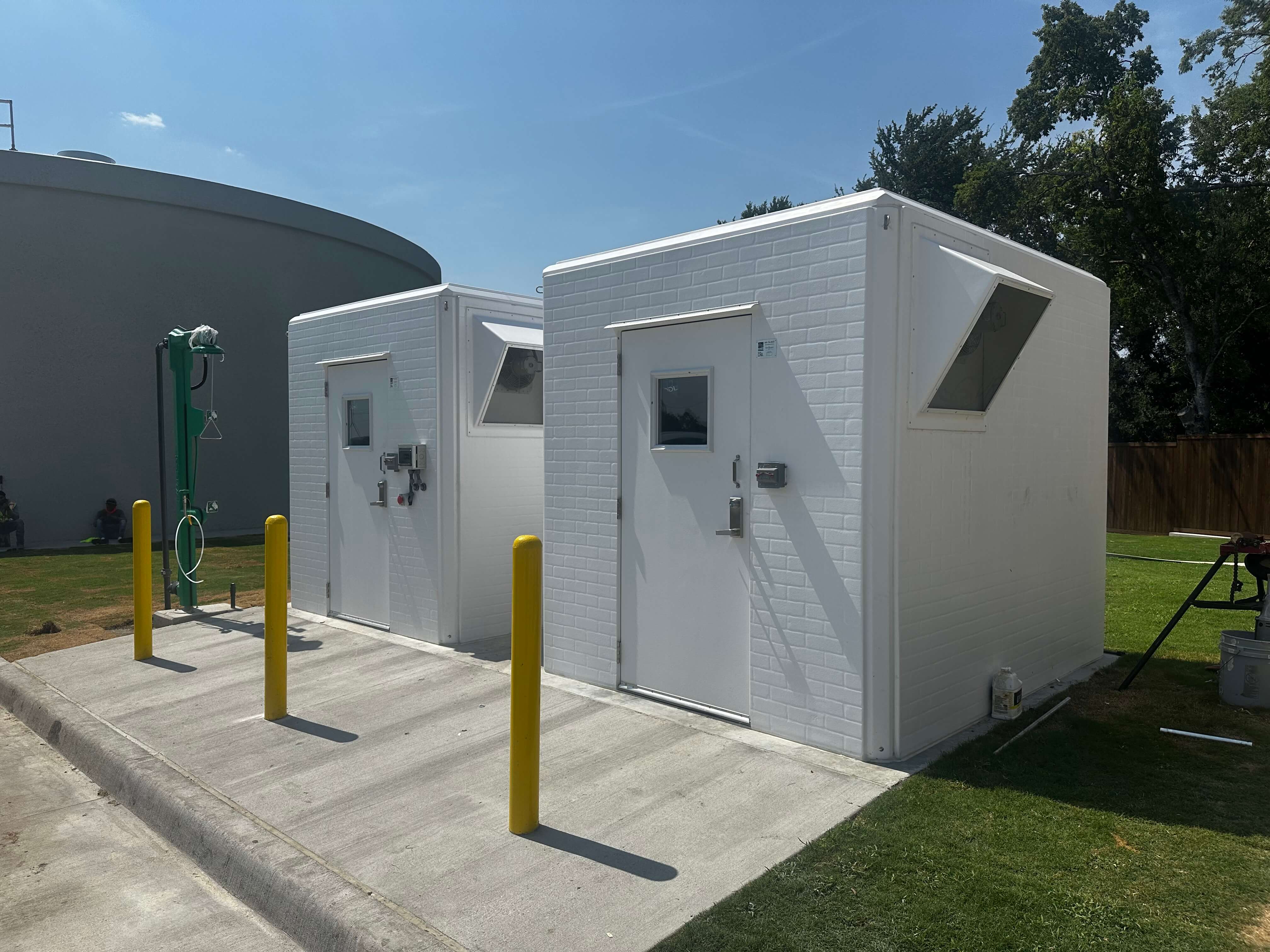 two prefabricated fiberglass chemical feed shelters built by Shelter Works