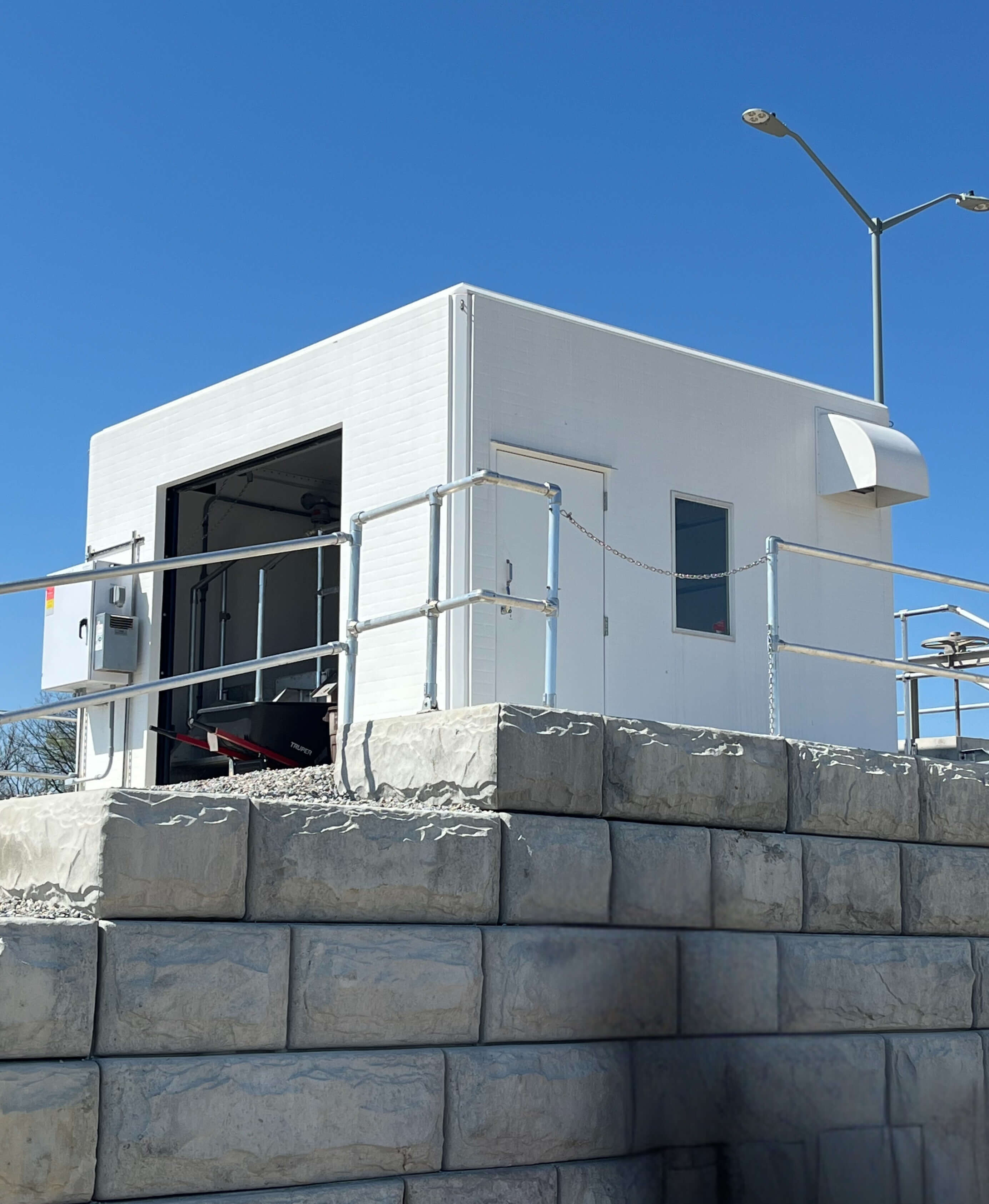 Fiberglass Headworks Building near a stone wall