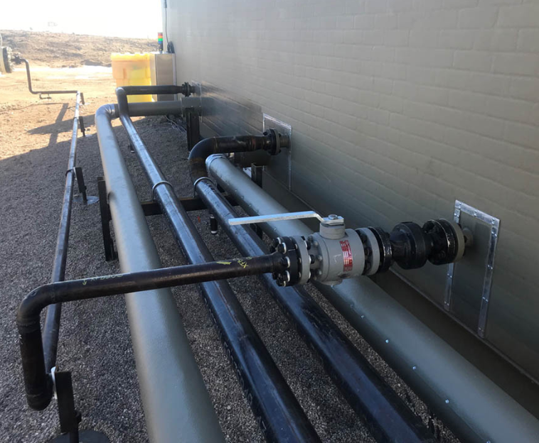 pipes integrated with a fiberglass equipment shelter