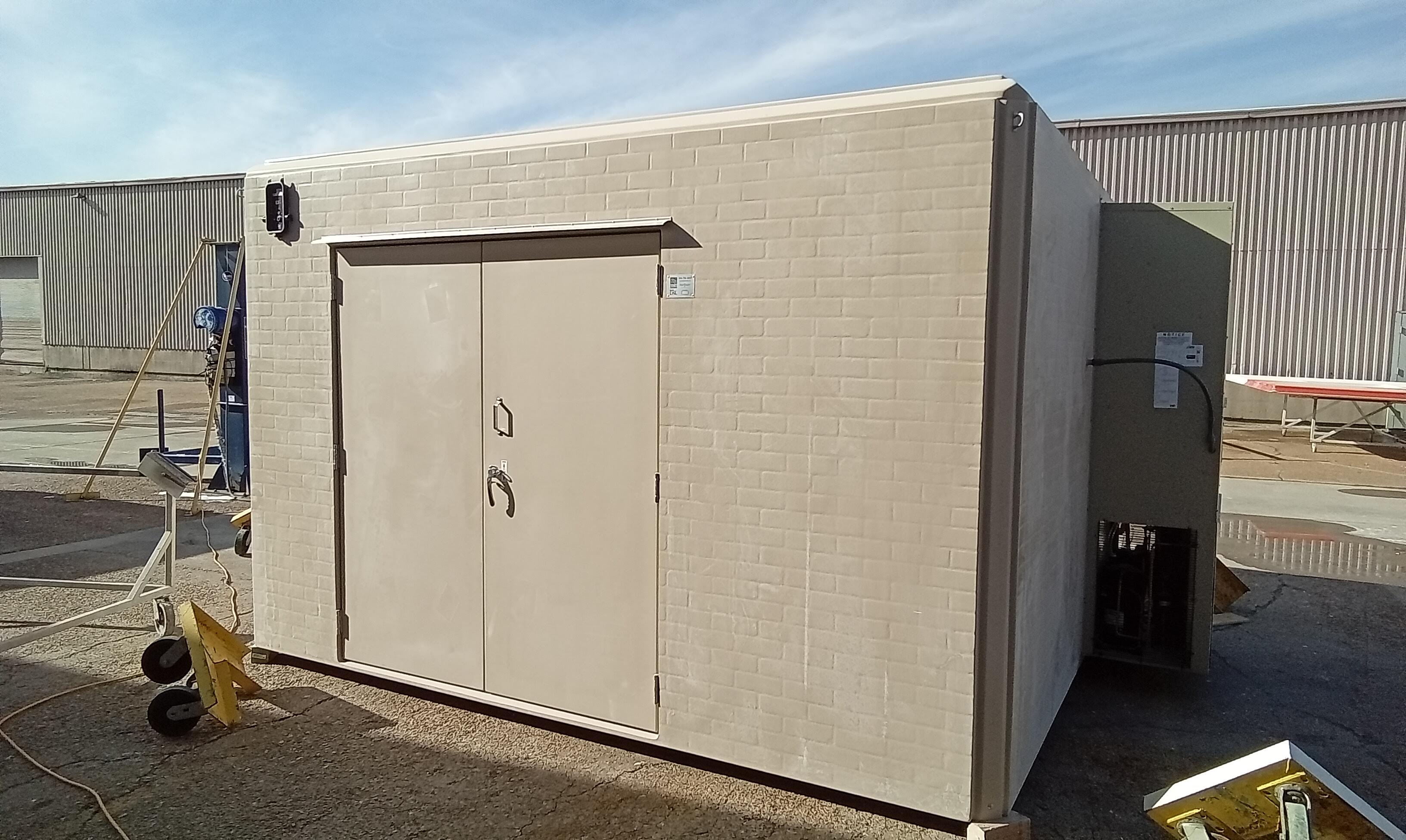 Tan Fiberglass Shelter for a Booster Pump Enclosure