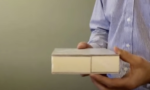 Tracy holds a cross section of the fiberbeam used in shelter construction