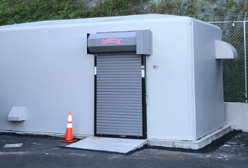 custom fiberglass shelter with automatic roll-up door
